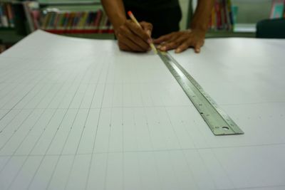 Midsection of man working on table