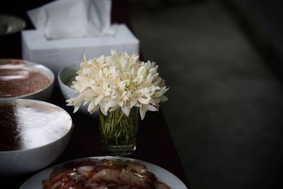 Close-up of white roses in vase on table