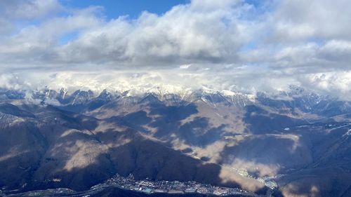 Aerial view of snowcapped mountains against sky