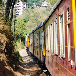 Toy train moving on mountain slopes, beautiful view, one side mountain, one side valley moving