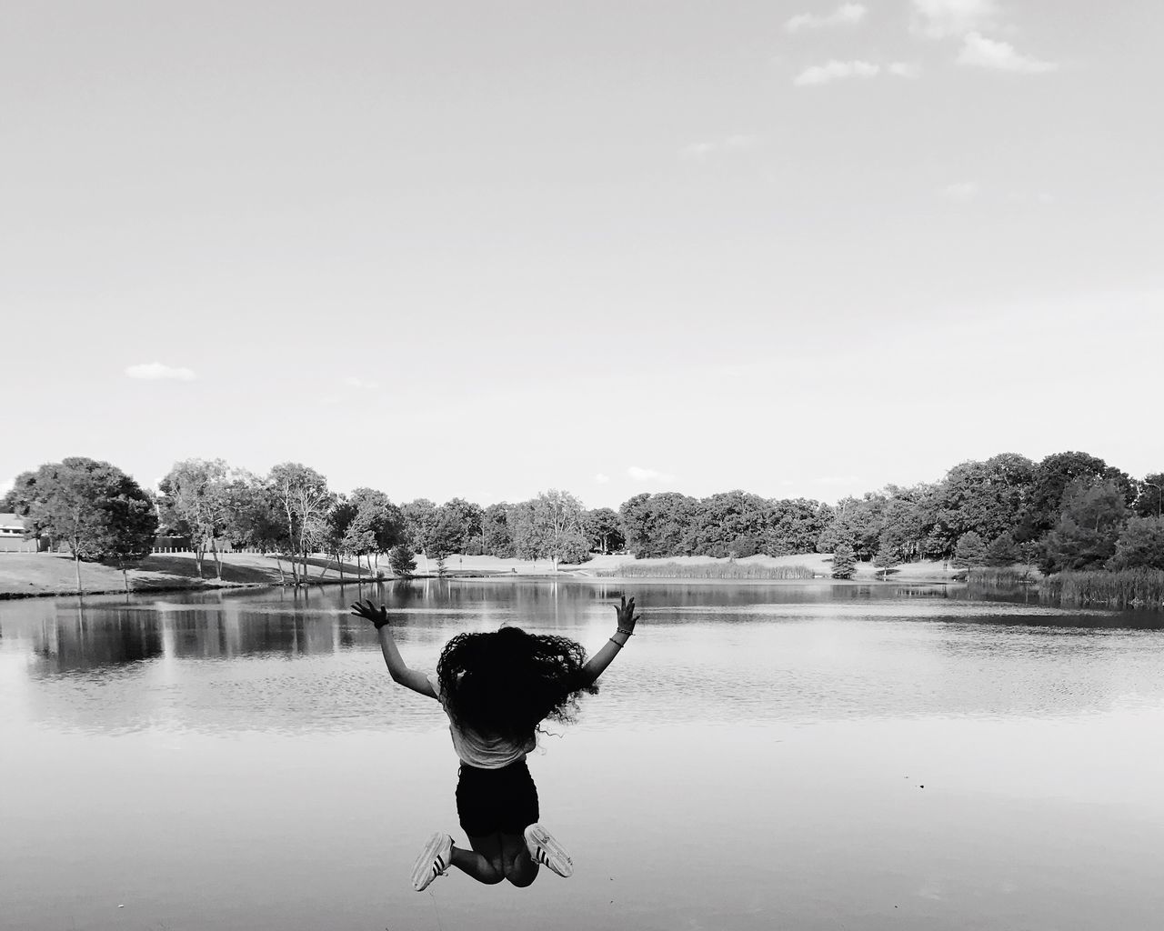 water, real people, rear view, arms raised, one person, tree, leisure activity, day, lifestyles, outdoors, nature, sky, men, beauty in nature, people