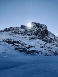 Scenic view of snowcapped mountains against clear blue sky