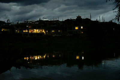 Illuminated city against sky at night