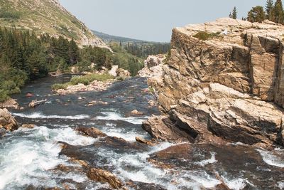 Scenic view of river amidst rocks against clear sky