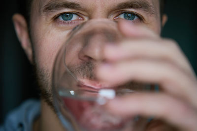 Close-up portrait of young man drinks water