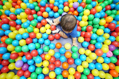 Rear view of boy playing with ball balls