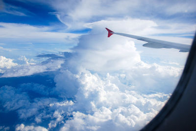 Aerial view of aircraft wing against sky