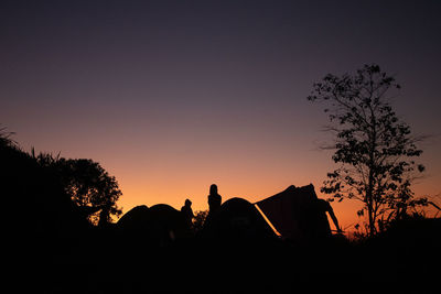 Silhouette trees against sky during sunset
