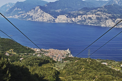 High angle view of cityscape by lake against sky