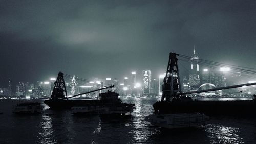 View of suspension bridge in city at night