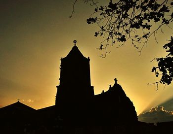 Low angle view of silhouette building against sky