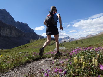 Full length of woman standing on mountain against sky