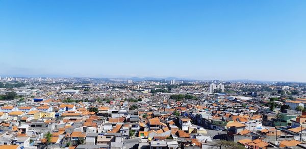 High angle view of townscape against clear blue sky