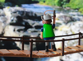 Man standing by railing on table