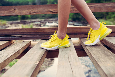 Low section of woman on wooden bench