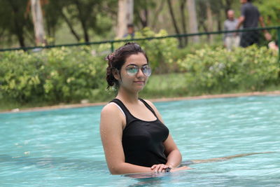 Portrait of young woman swimming in pool