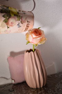 Close-up of pink rose flower vase on table