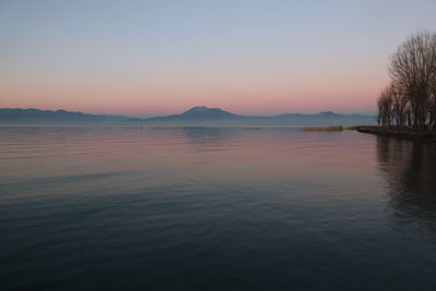 Scenic view of lake against sky during sunset