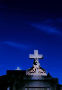 Low angle view of statue against blue sky