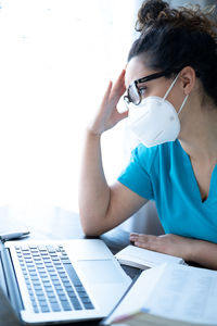 Portrait of man using laptop on table