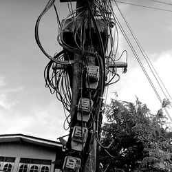 Low angle view of electricity pylon against sky