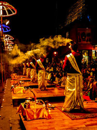 Crowd at illuminated city during night