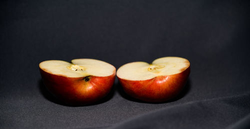 Close-up of fruits on table against black background