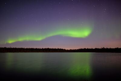 Scenic view of lake against sky at night