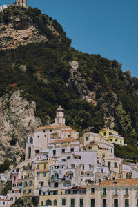 Buildings in town against clear sky