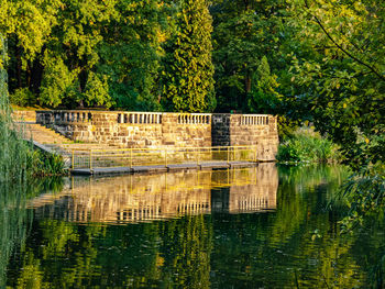 Built structure in lake against trees in forest