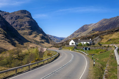 Road amidst mountains against sky