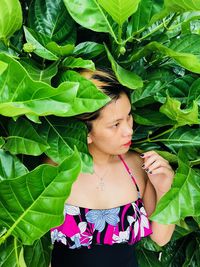 Young woman standing amidst plants