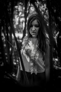 Young woman standing in forest