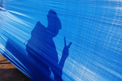 Shadow of man on blue sea