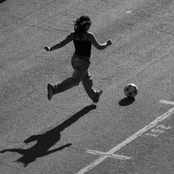 Full length of woman playing soccer