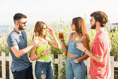 Friends standing against white background