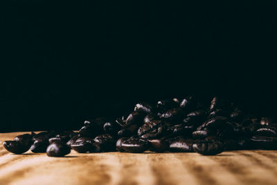 Close-up of coffee beans against black background