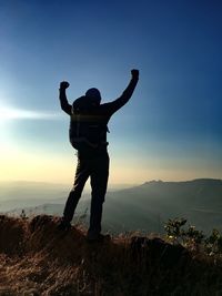 Full length of man standing on mountain against sky