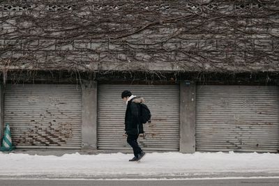 Full length of man walking on snow