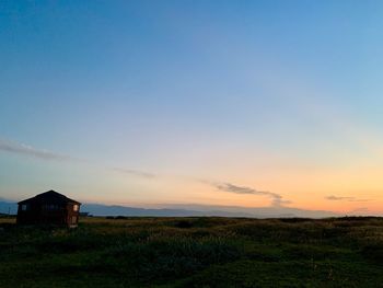 Scenic view of field against sky during sunset