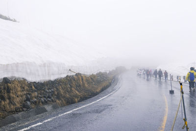 Road in city against sky during winter