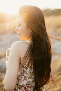 Young woman looking away outdoors