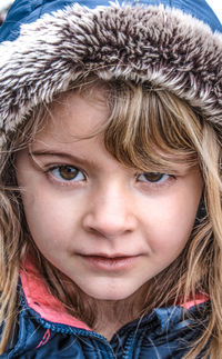 Close-up portrait of girl wearing warm clothing 