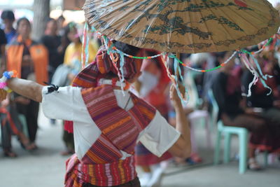 Rear view of woman wearing traditional clothing during festival
