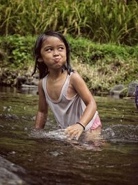 Portrait of happy girl in lake