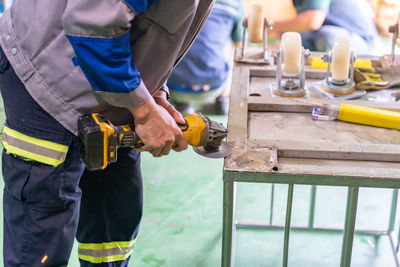 Midsection of man working in workshop