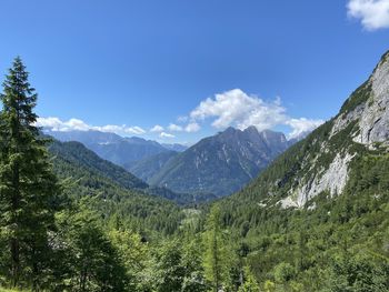 Scenic view of mountains against blue sky