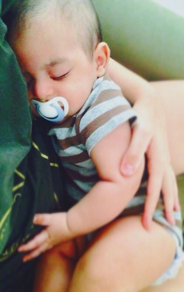 CLOSE-UP OF BABY BOY SLEEPING ON BED