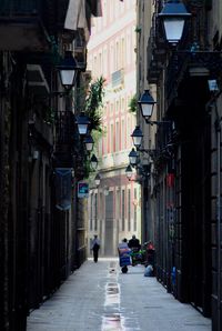 People walking on pathway along built structures