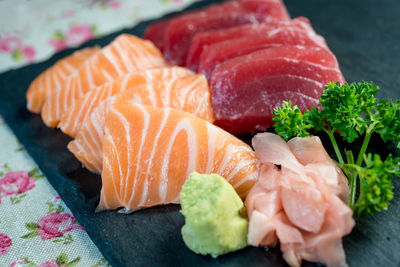 Close-up of sashimi on black cutting board